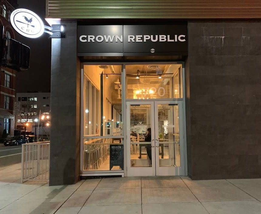Crown Republic Gastropub storefront at 720 Sycamore Street, downtown Cincinnati, lit in the evening