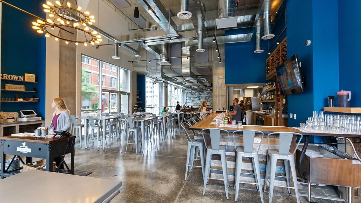 Host stand and bar in warm light at Crown Republic Gastropub
