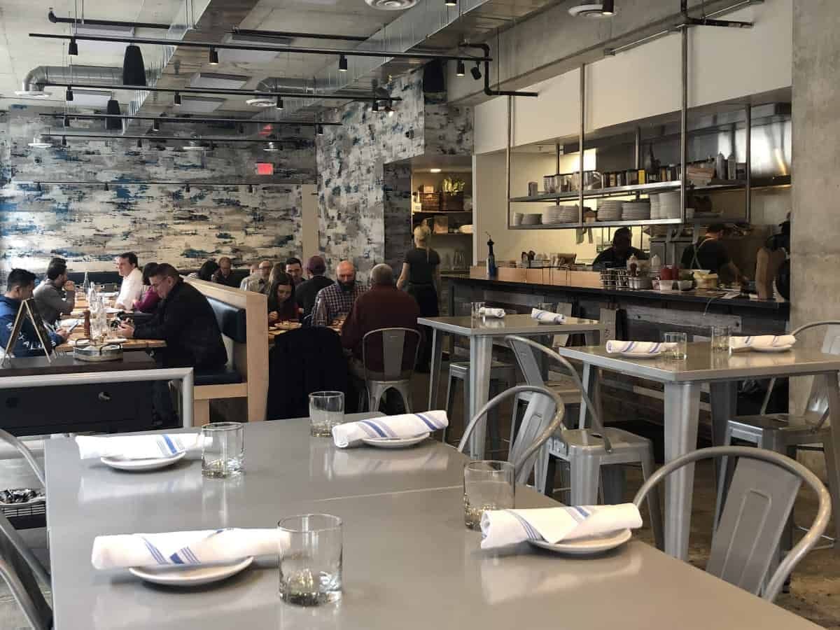 Warmly lit dining room full of guests at Crown Republic Gastropub in the evening